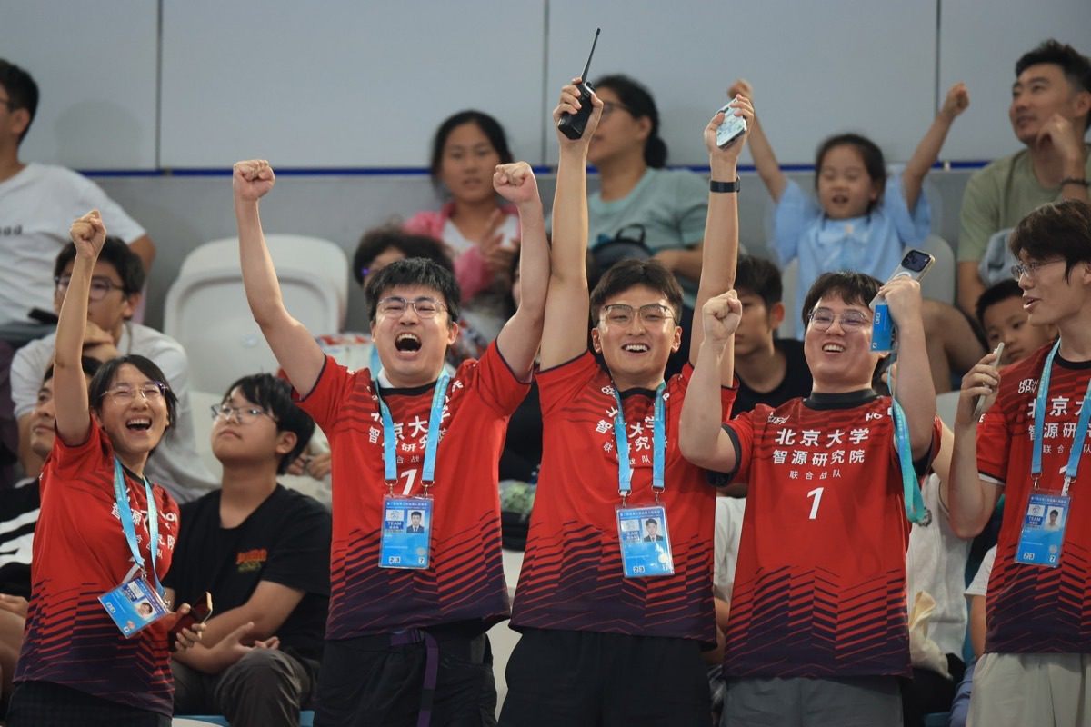 PKU–BAAI joint team celebrating the HOPE AI ping-pong title at the 2nd World Humanoid Robot Games